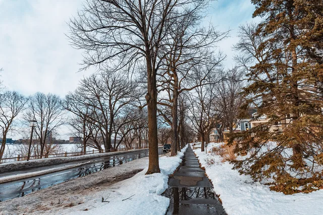 Sidewalks along East Calhoun Parkway and Bde Maka Ska are shoveled and clear of snow and ice, in Minneapolis, Minnesota, in winter. Comparing US and Canadian downtown sidewalk rules for winter walking