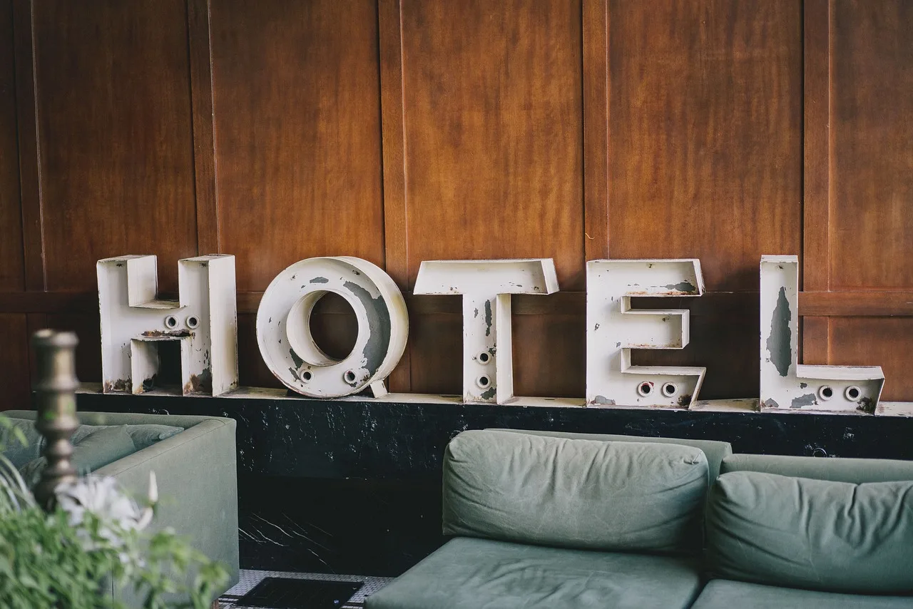 architecture, building, infrastructure, hotel, lobby, couch, brown building, brown couch, brown hotel, hotel, hotel, hotel, hotel, hotel, lobby. Pricing a two-night stay in a walkable downtown, line by line